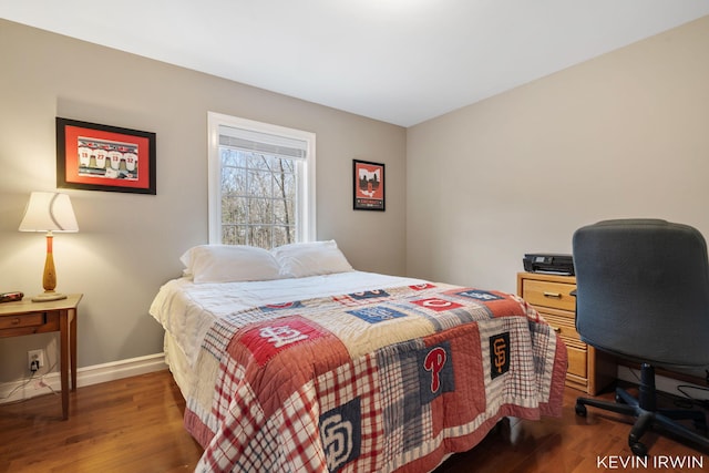 bedroom with baseboards and wood finished floors