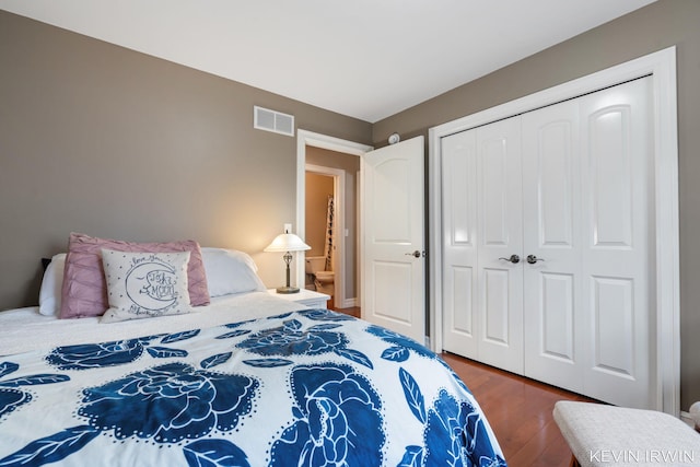 bedroom featuring visible vents, a closet, and wood finished floors