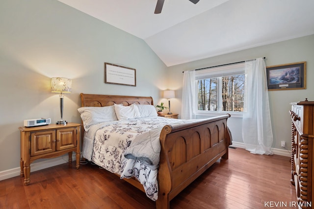 bedroom with dark wood-style flooring, a ceiling fan, baseboards, and vaulted ceiling