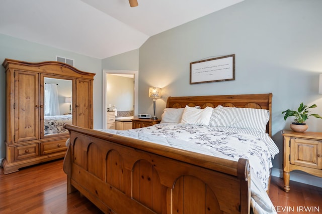 bedroom featuring visible vents, wood finished floors, connected bathroom, ceiling fan, and vaulted ceiling