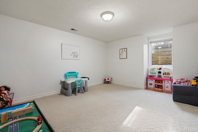 recreation room featuring baseboards, visible vents, and carpet floors