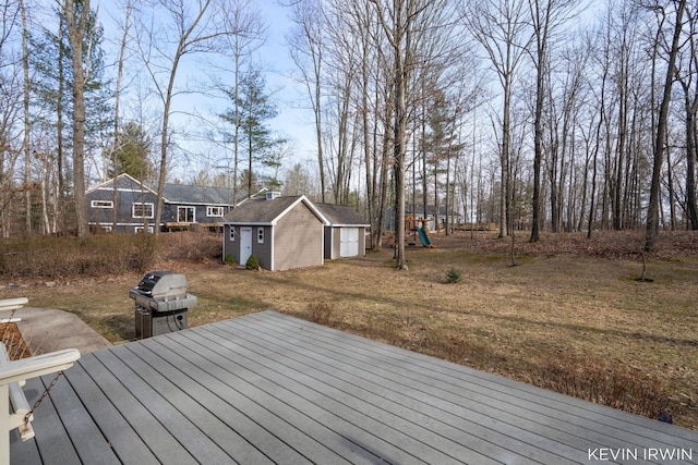 deck with a playground and an outdoor structure