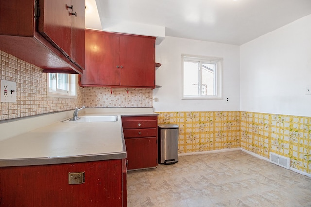 kitchen with visible vents, wainscoting, baseboards, and a sink