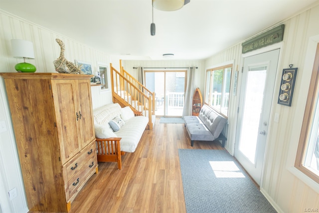 living room featuring light wood-style floors and stairs