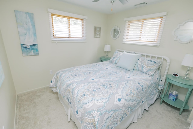 carpeted bedroom with visible vents and ceiling fan