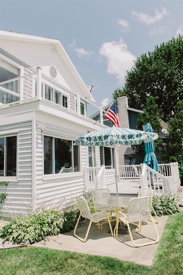 rear view of house featuring a balcony