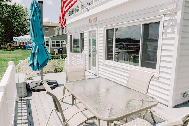 wooden deck featuring outdoor dining area