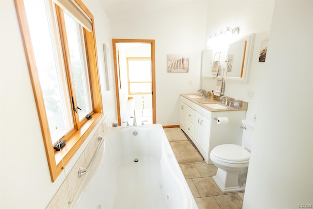 full bath featuring tile patterned floors, a tub with jets, toilet, and a sink