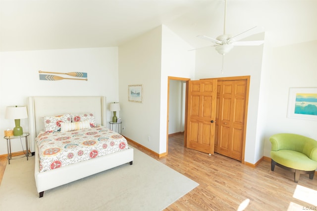 bedroom with high vaulted ceiling, baseboards, light wood-type flooring, and ceiling fan