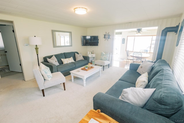 living room featuring a wealth of natural light, light carpet, and a ceiling fan