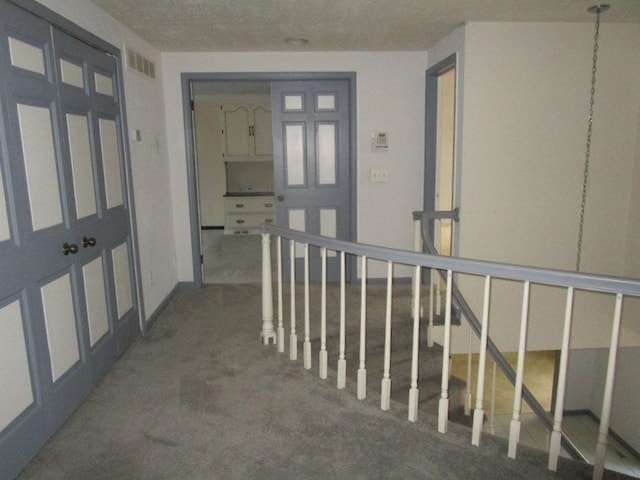 corridor with an upstairs landing and visible vents