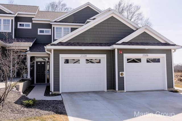 view of front facade featuring driveway and a shingled roof