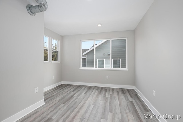 empty room featuring baseboards and wood finished floors