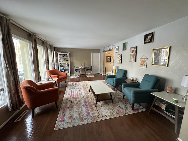 living area with wood finished floors and visible vents