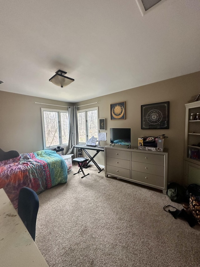 carpeted bedroom featuring visible vents