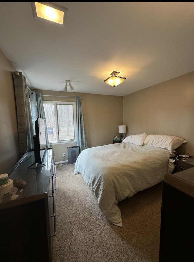 carpeted bedroom featuring baseboards