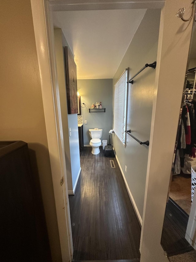 bathroom featuring toilet, baseboards, and wood finished floors