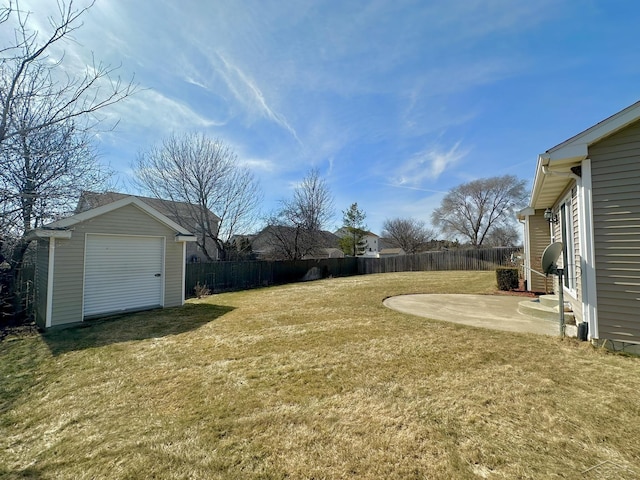 view of yard featuring a storage unit, a fenced backyard, a patio, and an outdoor structure