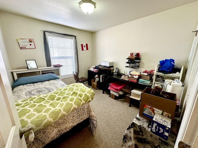 carpeted bedroom featuring a textured ceiling