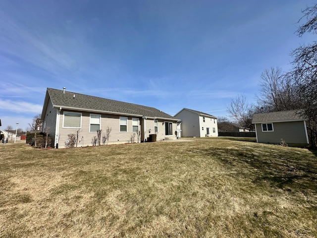 rear view of house featuring a lawn