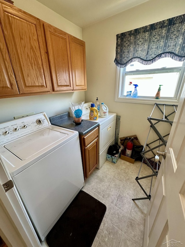 laundry area featuring cabinet space and separate washer and dryer