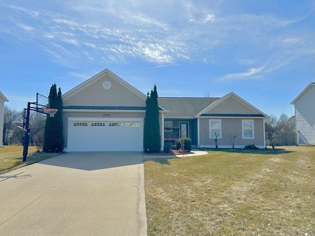 ranch-style house featuring a front yard, an attached garage, fence, and driveway