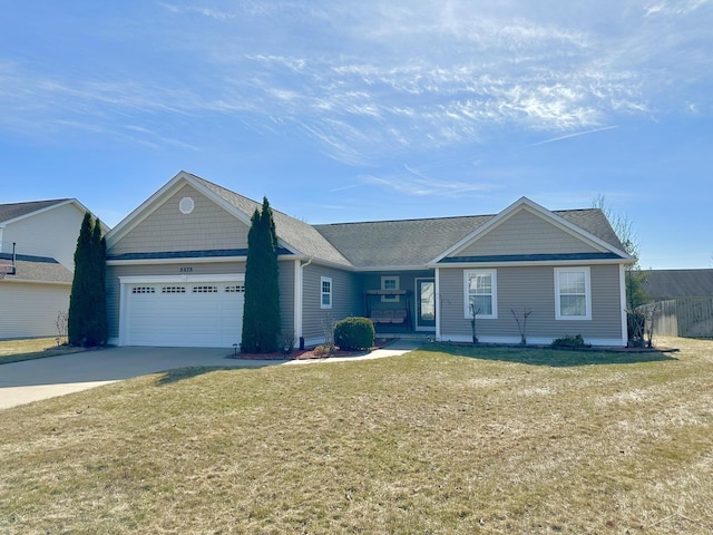 ranch-style house featuring an attached garage, concrete driveway, and a front yard