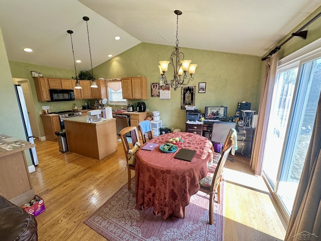 dining room with an inviting chandelier, vaulted ceiling, recessed lighting, and light wood finished floors