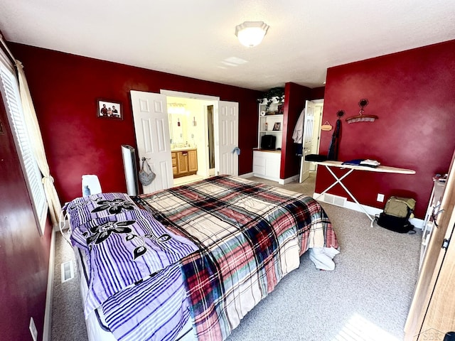 carpeted bedroom featuring visible vents and baseboards