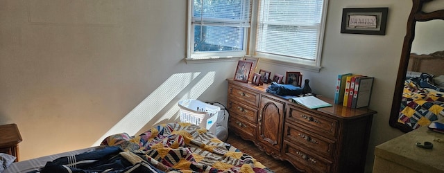 bedroom with dark wood-type flooring