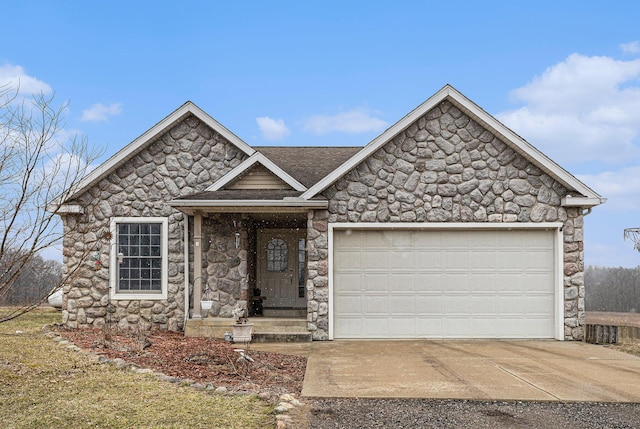 view of front of property with a garage, stone siding, and driveway