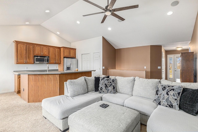 living area with high vaulted ceiling, a ceiling fan, recessed lighting, baseboards, and light colored carpet