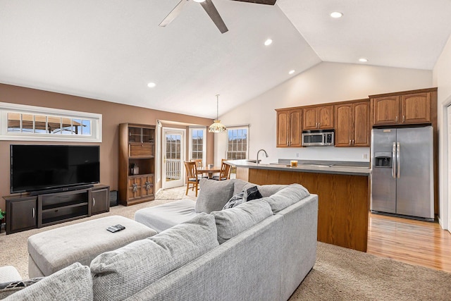 living area with recessed lighting, light carpet, high vaulted ceiling, and a ceiling fan