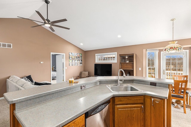 kitchen with visible vents, open floor plan, dishwasher, vaulted ceiling, and a sink