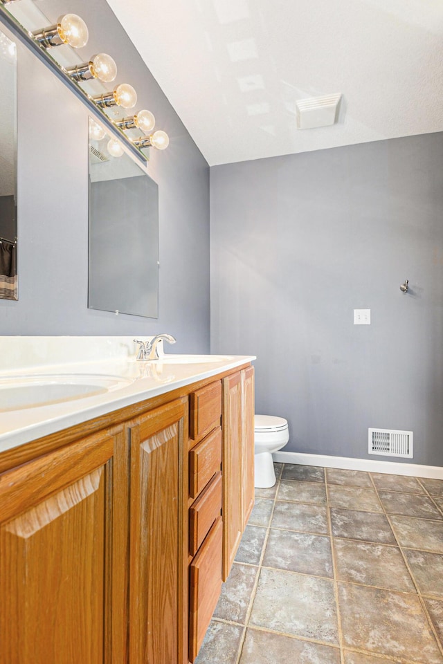 bathroom with visible vents, baseboards, toilet, and vanity