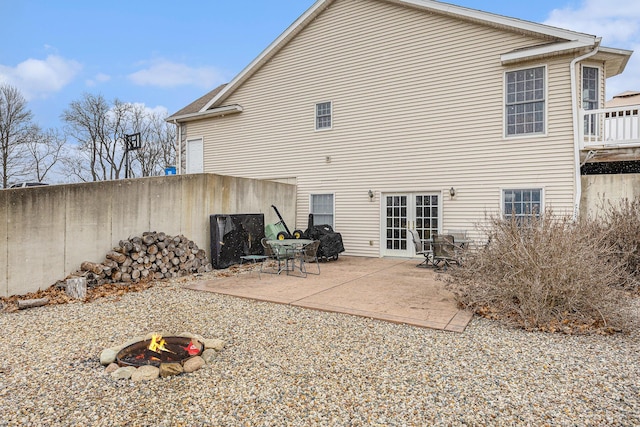 back of house featuring a patio area, french doors, a fire pit, and fence