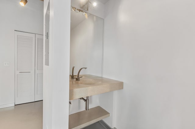 bathroom with finished concrete flooring and a sink