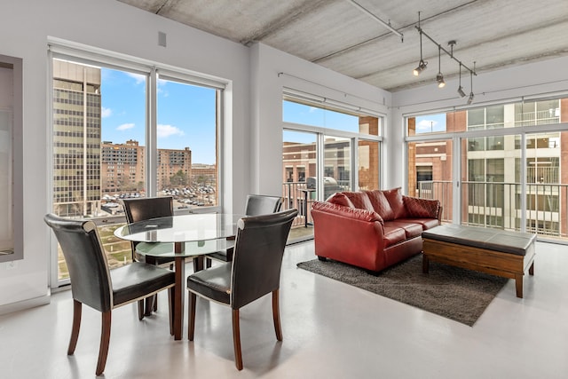 dining area with a city view and finished concrete floors