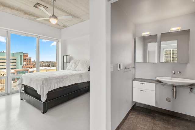 bedroom with a sink, baseboards, and a ceiling fan