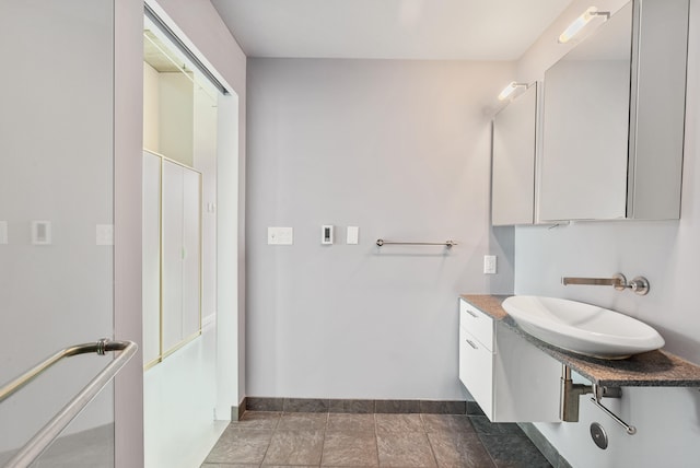 bathroom with vanity and baseboards