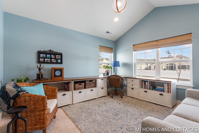 carpeted home office with visible vents and high vaulted ceiling