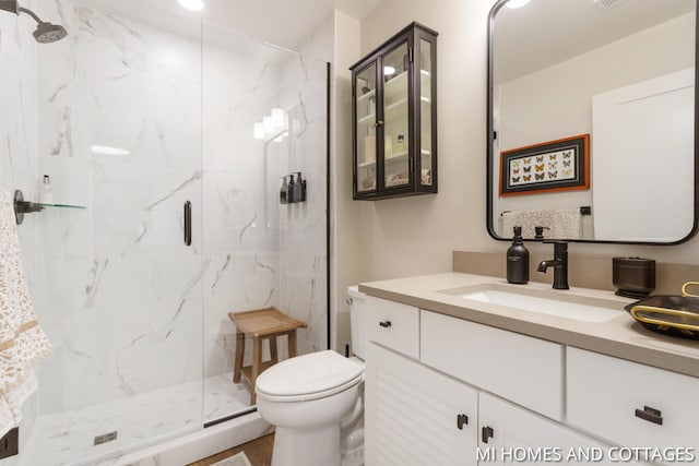 full bath with vanity, toilet, visible vents, and a marble finish shower