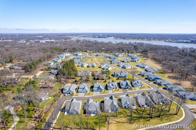 drone / aerial view with a residential view and a water view