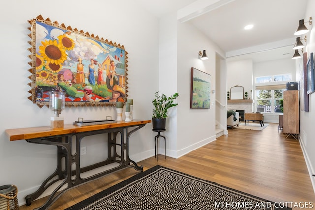 corridor featuring recessed lighting, wood finished floors, and baseboards