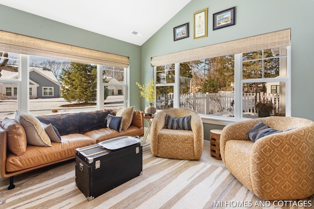 sunroom / solarium featuring visible vents and lofted ceiling