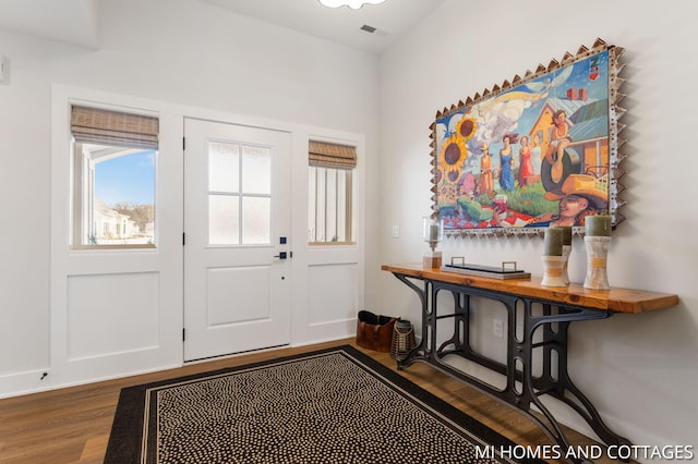 entrance foyer with visible vents, baseboards, and wood finished floors