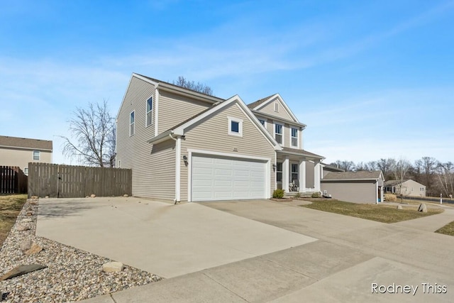 traditional home with driveway and fence