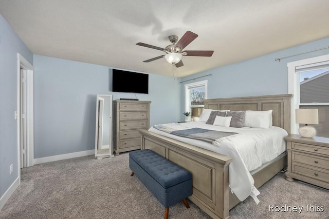 carpeted bedroom with baseboards and ceiling fan