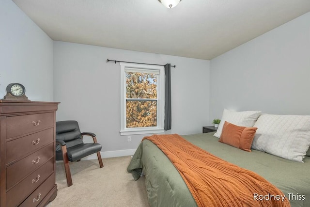 bedroom featuring baseboards and light carpet