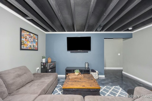 living area featuring baseboards and concrete flooring